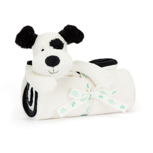 The Jellycat Bashful Black & Cream Puppy Blankie, made from recycled fibers, includes a black and white stuffed dog toy attached to a rolled-up white blanket, tied with a "baby" and "patch" ribbon. It's perfect for providing comfort to little ones with Baby Jellycat charm.
