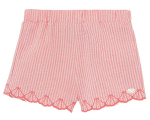Tartine et Chocolat's Baby Girls' and Girls' Coral Seersucker Shorts feature scalloped embroidery along the hem, delicate embroidered shells, and a small decorative patch on one leg for added charm.