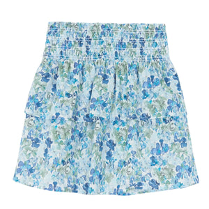 The Tartine et Chocolat Girls' Floral Skirt, made from Liberty fabric in blue and green floral patterns, includes a smocked waistband and tiered design, perfect for your summer look.