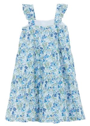 The Tartine et Chocolat Girls' Floral Dress features ruffled straps, a layered skirt, and blue-green flowers on a white background, offering a fresh and stylish charm for any sunny day outing.