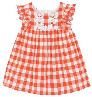 This charming red gingham dress for baby girls by Tartine et Chocolat features ruffled sleeves and delightful embroidered flower detailing on the front.