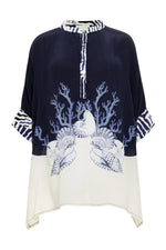 The Ayya Mini Dress by Carolina K features loose fit, navy and white color blocking, sea-inspired prints of coral, seashells, and starfish, striped collar and cuffs accents. Designed in collaboration with a renowned South African artist.
