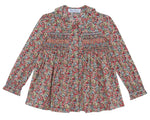 The Tartine et Chocolat Girls' Liberty Smocked Floral Tunic features long sleeves, a vibrant all-over Liberty floral print, and smocked detailing on the chest and upper arms.