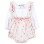 The Tartine et Chocolat Baby Girls' Overall Outfit includes a long-sleeve white ruffled collar bodysuit and a floral-patterned pink suspender skirt with lace and red trim.