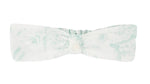 The Tartine et Chocolat Headband features a white design with a light green marble pattern and bow-tie style, shown on a plain background—an elegant addition to your baby’s hair accessories.