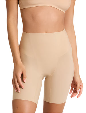 A person models Commando's Zone Smoothing Shorts in nude, paired with a matching bra, from shoulders to mid-thigh, showcasing the smooth silhouette these seamless high-waisted shorts create.