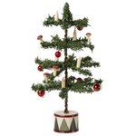 The Maileg Christmas Tree, Mouse is a small artificial tree with red baubles, candle-shaped ornaments, and mushrooms, set in a round white base decorated with black triangles.