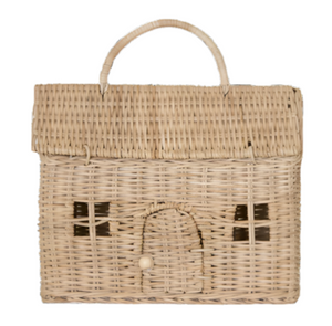 The Olli Ella Casa Clutch, Straw is a charming rectangular wicker basket crafted from natural rattan, designed to resemble a toy house with window details and an arched door. It includes a top handle for easy carrying.