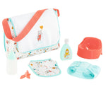 The Corolle Baby Doll Changing Bag + Accessories set from the Mon Grand Poupon collection includes a bottle, pacifier, bib, baby lotion, diaper, and red potty. Perfect for little caregivers on the go!.