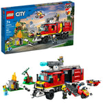 The LEGO® City Fire Command Truck set includes a toy fire engine, firefighter minifigures, a small fire scene, and accessories. With 502 pieces, this LEGO® construction set is perfect for ages 7 and up. Box and assembled pieces shown.