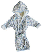The Timo & Violet Kids' Bathrobe is an ultra-soft velour cotton terry robe with blue trim and a Coral Reef print, shown flat with sleeves and belt extended.