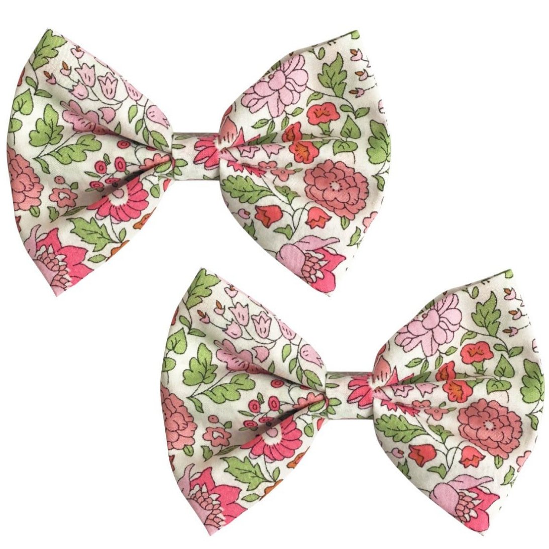 Two Milledeux Girls' Large Bowtie Bows in Liberty D’Anjo C fabric, featuring a pink, green, and white floral pattern, are displayed side by side on a plain background.