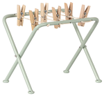 The Maileg Drying Rack with Pegs, Miniature features six large wooden clothespins on top bars—ideal for adding charm to your laundry or air-drying tiny teddies and bunnies.