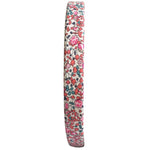 Side view of Milledeux Girls' Medium Plain Hairband – Liberty Eloise C, covered in white Liberty fabric with a pink, red, and blue floral pattern. Ideal for those who love unique, handmade accessories.