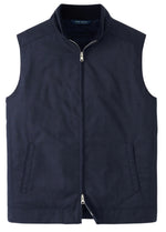 The Excursionist Lite Vest by Peter Millar is a stylish dark blue sleeveless vest made from lightweight, water-resistant wool. It features a front zipper and two side pockets, making it ideal for an elegant look against any backdrop.