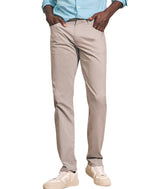 A person wearing a blue checkered shirt, Faherty's Movement Five Pocket Pants with 4-way stretch for comfort, and white sneakers.