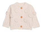The Louise Misha Baby Girls' and Girls' Sandy Cardigan is a cream knit with long sleeves, button front, and hand-crocheted flower appliqués on the front and sleeves.
