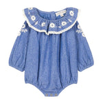 The Louise Misha Baby Girls' Ilani Romper features long sleeves, white floral embroidery, lace-trimmed ruffled collar, elastic cuffs, and convenient snap buttons at the bottom.