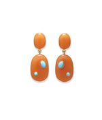 The Satsuma Earrings by Lizzie Fortunato are orange resin drop earrings with gold fittings, each adorned with two small turquoise-colored stones set irregularly.