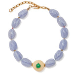 The Andalusia Collar by Lizzie Fortunato features light purple oval beads, gold spacers, an adjustable gold clasp, and a central round cream bead accented with green chrysoprase.