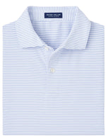The "Ambrose Performance Jersey Polo" by Peter Millar, featuring light blue and white stripes, a collar, and buttons, offers four-way stretch for comfort and UPF 50+ sun protection—ideal for sunny days.