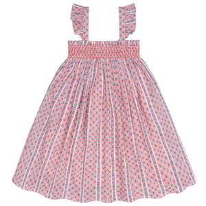 The Minnow Girls' Floral Tile Smocked Dress features a pink and white floral pattern, flutter sleeves, and ruffled shoulder straps, shown against a white background.