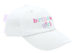 The Birthday Girl Bow Baseball Hat by Bits & Bows features "birthday girl" embroidered in colorful letters, a pink-striped adjustable strap, and a seersucker bow at the back.