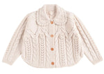 The Girls' Khellana Cape Sweater by Louise Misha is a cream-colored knitted cardigan featuring a delicate Peter Pan collar, cable knit pattern, and wooden buttons down the front.