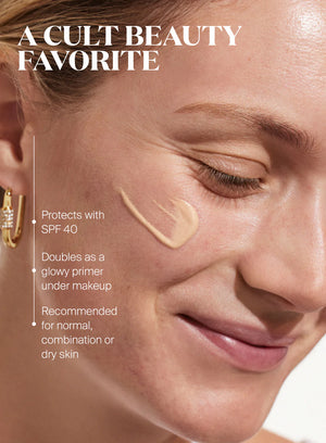 A woman smiles with Glowscreen SPF 40 in Sunrise by Supergoop on her cheek. Text highlights its SPF 40 protection, all-day hydration, makeup primer use, and suitability for multiple skin types.