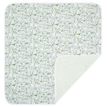 The Joy Street Golf Baby Blanket, made from soft pima cotton, showcases a green and white jungle animal print with a striped underside, ideal for any baby's comfort.