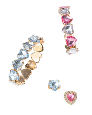 The Super Smalls Heart to Heart Mega Set by Super Smalls includes three adjustable gold rings with heart-shaped gems: one adorned with blue stones, another with pink stones, and a third featuring a single pink jewel encircled by smaller clear stones. They come perfectly arranged in an elegant gift box.