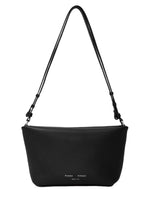 The Proenza Schouler Bond Smooth Nappa Bag is a minimalist black leather design with a single crossbody strap and subtle front logo branding.