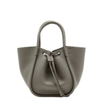 The Proenza Schouler Small Ruched Soft Pebbled Calf Tote in gray leather features a sculptural silhouette, drawstring closure, and double handles, displayed against a plain white background.
