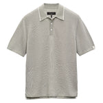 The Harvey Knit Polo Shirt by Rag & Bone is a light gray, short-sleeve polo crafted from a lightweight cotton blend with textured fabric, a three-button placket, and a white label on the left sleeve—ideal for year-round wear.
