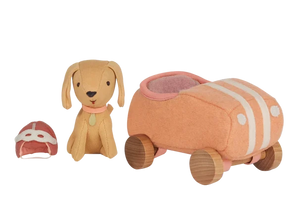 The Olli Ella Holdie Dog Go set features a stuffed toy dog, a matching car with wooden wheels, and a tiny fabric helmet, all arranged on a white background.