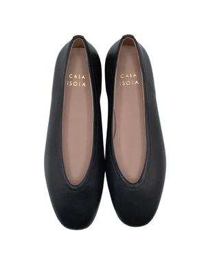 A pair of black Dafne Leather Flats by Casa Isota, crafted in supple Nappa leather with rounded toes. Tan insoles display gold "CASA ISOTA" lettering. Expertly made by Italian artisans for timeless elegance.