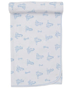 The Giraffe Grace Blanket by Kissy Kissy is a white Pima cotton baby blanket featuring blue printed illustrations of children in dresses, neatly rolled at the top edge.