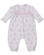 The Kissy Kissy Baby' Giraffe Grace Playsuit is a white long-sleeve Pima cotton playsuit with a pink giraffe print, ruffled cuffs, and snap buttons at the back and legs.