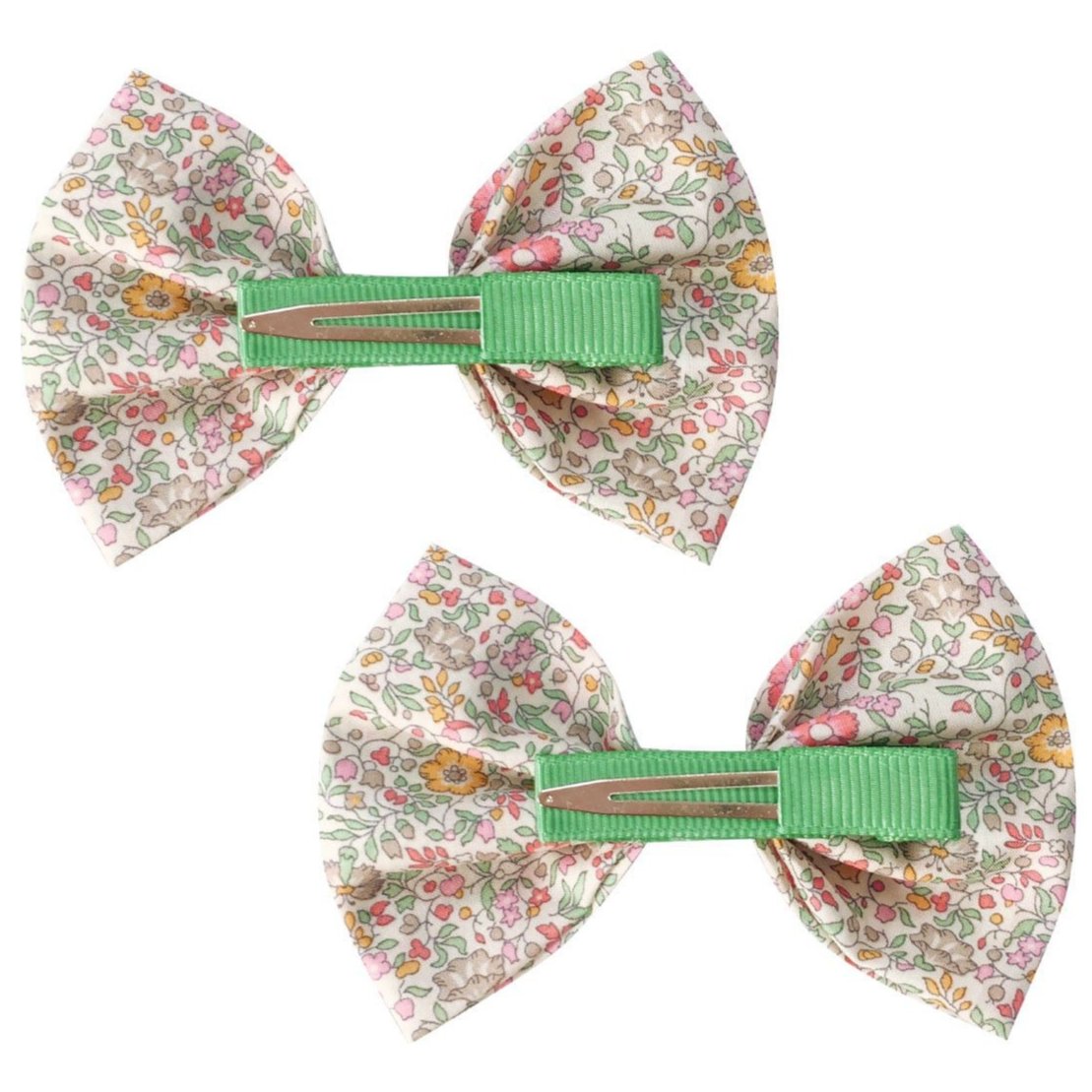The Girls' Large Bowtie Bow Liberty Katie & Millie B by Milledeux features two charming bow-shaped hair clips with a delightful floral pattern and green center, crafted from Liberty of London fabric and securely fastened with grosgrain-covered alligator clips.