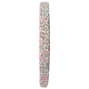A side-view of the Girls' Medium Plain Hairband by Milledeux reveals pink, green, and yellow flowers on white Liberty Katie & Millie B fabric, blending charm and elegance effortlessly.