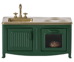 The Maileg Kitchen, Mouse in Dark Green is a charming miniature play kitchen featuring a brass sink, two stovetop burners, and a small visible dish inside the oven—ideal for little mouse family culinary adventures.
