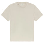 The Frame Logo Tee, a premium beige cotton crewneck with short sleeves, is displayed flat on a white background. A small neck label reads "FRAME.