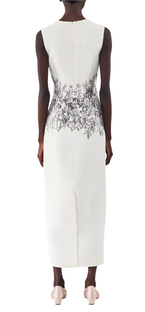 The Adam Lippes Ophelia Silk Wool Dress is a sleeveless ivory creation featuring a floral print on the back, elegantly contrasting with its crisp white background.