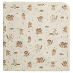The Magnetic Me Where the Wild Things Are Blanket is a cream-colored modal baby blanket with playful wild creature and crowned boy illustrations, offering softness and temperature regulation—ideal as a stroller blanket.
