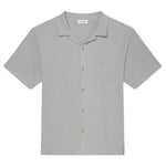 The Frame Jacquard Short Sleeve Relaxed Shirt in light gray features textured cotton, a notched collar, single chest pocket, and is displayed flat on a white background.