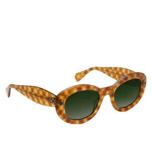 The Margaret Sunglasses by Krewe have a tortoiseshell pattern with a circular design, featuring round green lenses and thick frames, embodying a modern pop icon aesthetic against a crisp white background.