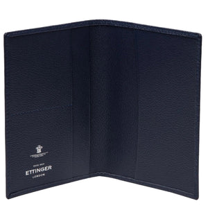 Open navy Capra Passport Case in leather, featuring card slots and an interior with a visible Ettinger logo.