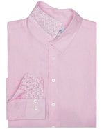 The Mens' Solid Linen Shirt by Pink House Mustique is a folded light pink, breathable linen shirt featuring a patterned inner collar and cuff detail, finished with white buttons.