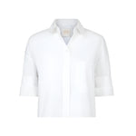 The TWP Next Ex Shirt is a white, short-sleeved, collared button-up with a chest pocket and boxy silhouette, shown against a plain background.