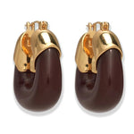 Lizzie Fortunato's Organic Gold Hoops feature gold-toned metal tops and curved dark brown resin bottoms for a bold, modern look.